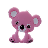 A silicone teether in the shape of a koala with a pink body and facial features, including large eyes and a small nose.