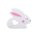A silicone teether in the shape of a white bunny rabbit with pink inner ears and a heart-shaped cutout in the center.