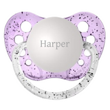 A personalized pacifier with the name 'Harper' engraved on it, with a silicone orthodontic nipple.