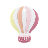 A silicone teether in the shape of a hot air balloon, featuring shades of pink and yellow with a basket at the bottom.