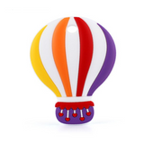 A silicone teether in the shape of a hot air balloon, featuring primary colors with a basket at the bottom.