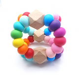 A teething toy in the shape of a triangle, featuring a variety of colorful silicone beads and wooden beads for chewing and playing.