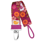 A pacifier clip with a floral pattern in pink and orange colors, featuring a safety ring and a brand tag.